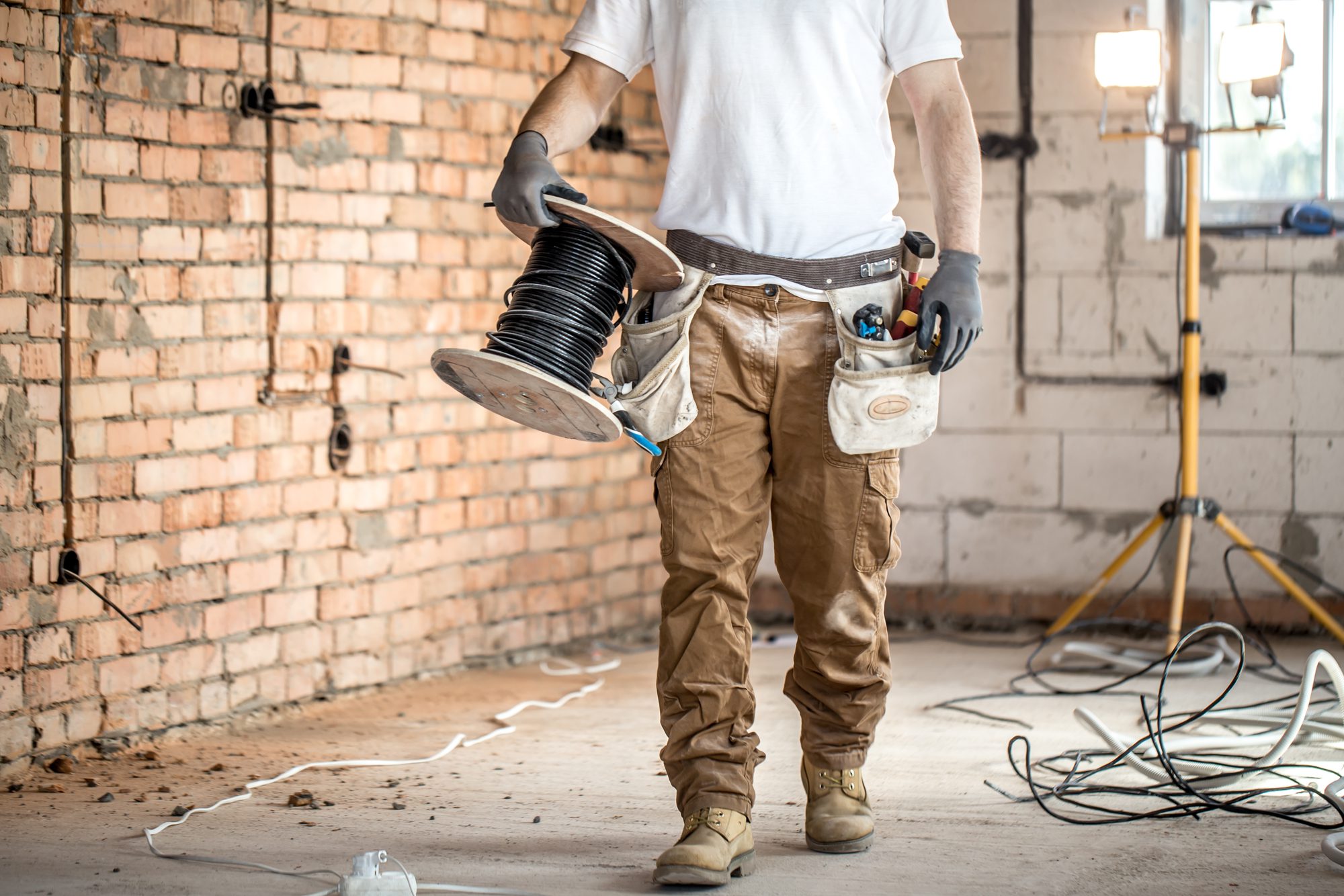 Electrician With Tools, Working on a Construction Site.